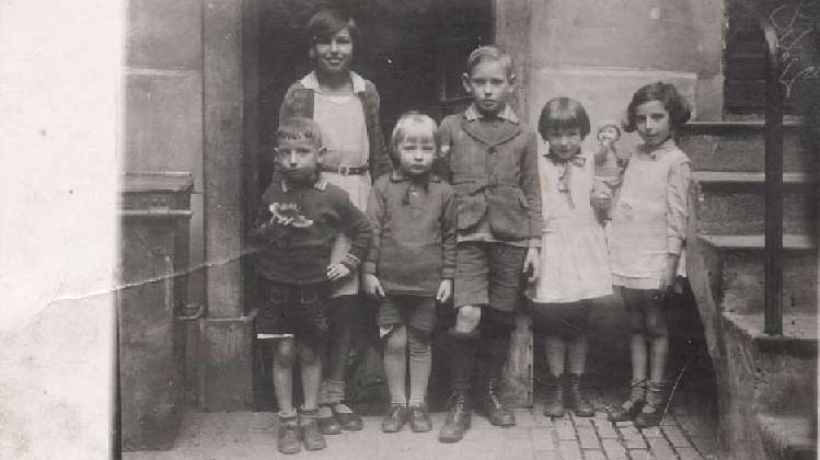 Photo of children next to a staircase 