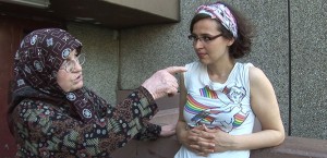 An elderly woman talks to a young woman