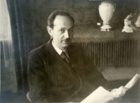 Portrait of Max Karp with newspaper