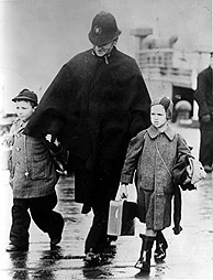 Ein britischer Polizist mit zwei Kindern nach Ankunft eines Kindertransportes, Harwich, Essex (Großbritannien) 12.12.1938