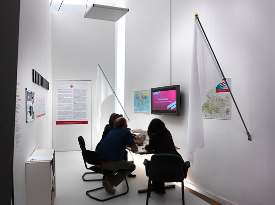 Visitors sitting arounf an office table