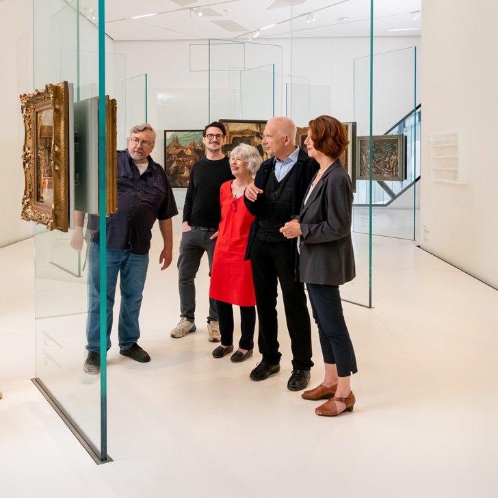 Visitors to the Jewish Museum look at paintings.