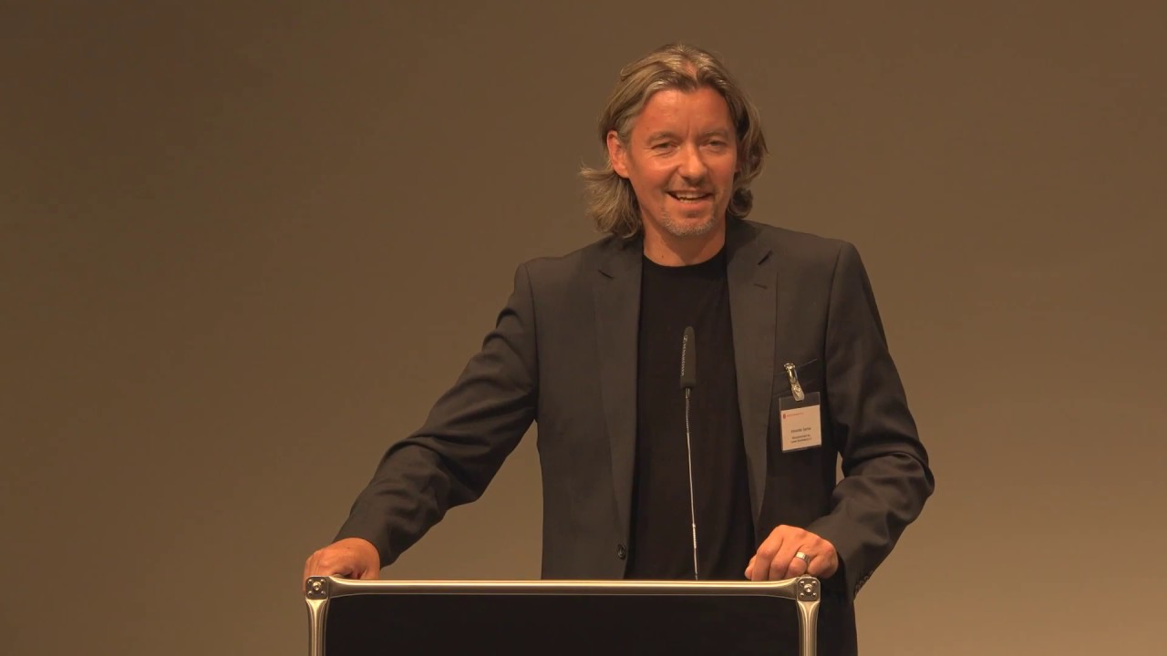 Man at the lectern gives a lecture.