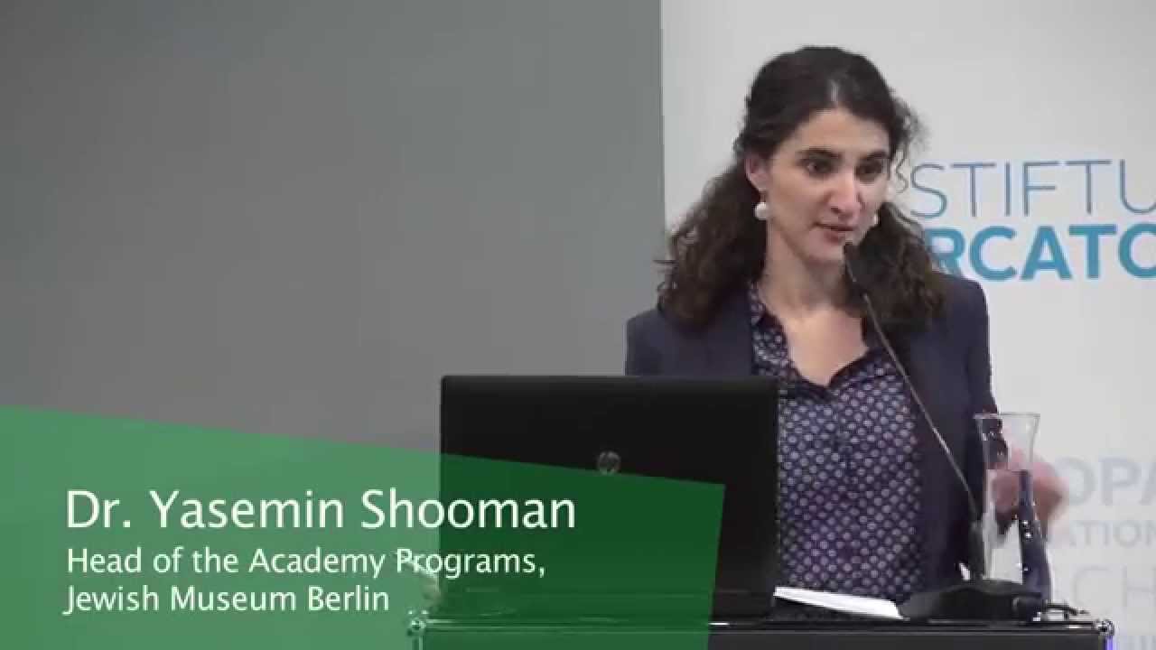 Woman stands at a lectern and gives a lecture.