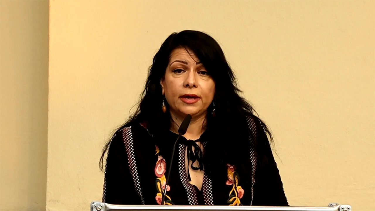 Woman speaking at the lectern.