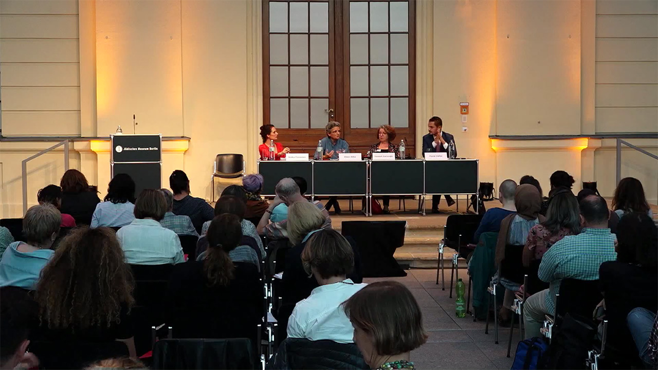 Lecture hall with panel of four.