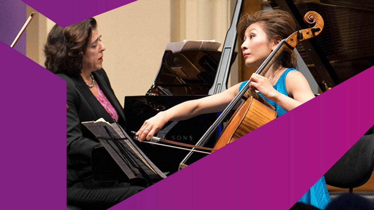 A woman at the grand piano and one at the cello make music together.