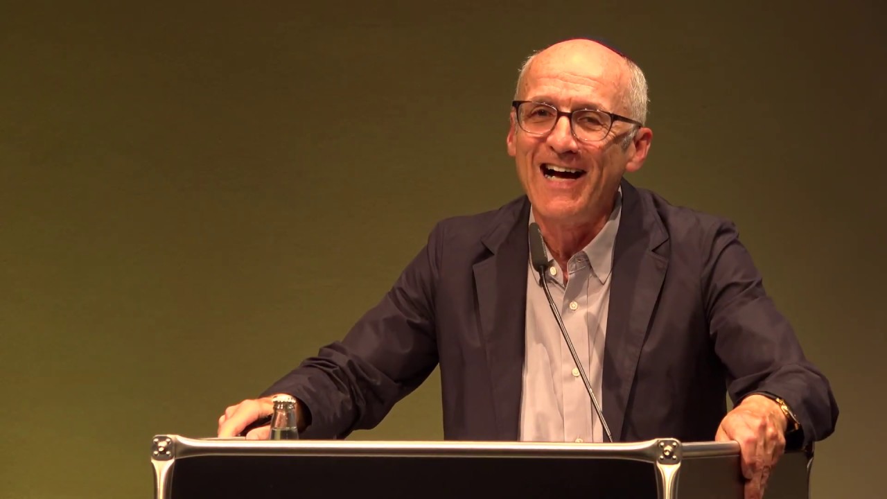 James A. Diamond stands at a lectern and gives a lecture