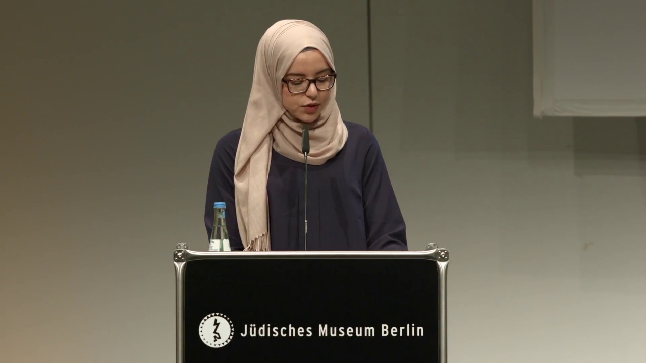 Hafssa El-Bouhamouchi stands at the lectern