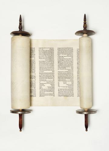 Torah scroll with wooden handles and Hebrew characters