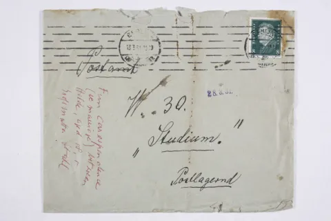 Old envelope. It is handwritten in black and red.