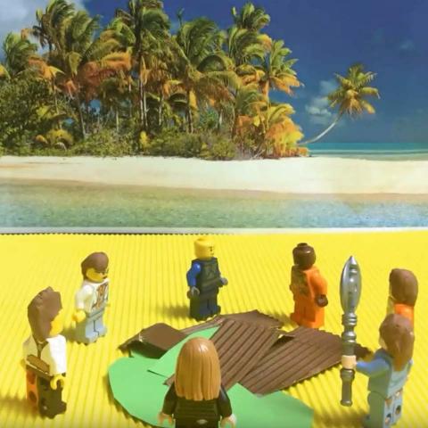 Various Lego figures stand around a pile of paper, tropical islands can be seen in the background.