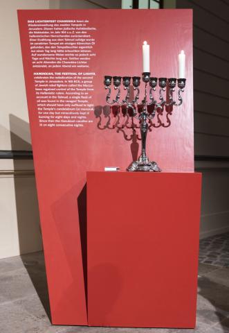 Hanukkah candelabra with two burning candles.