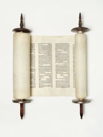 Torah scroll with wooden handles and Hebrew characters