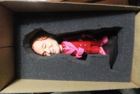 Red-haired doll in a box with styrofoam