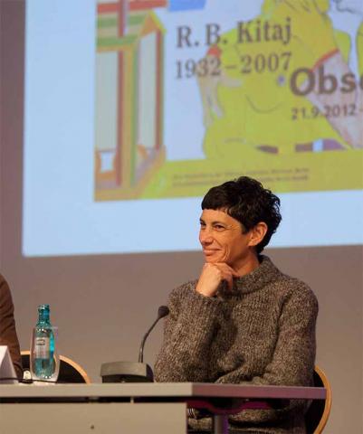 Laughing woman with black short haircut on a podium
