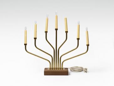 A menorah with electric light bulbs and a cable.