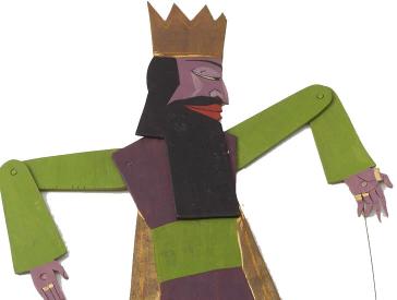 Spielfigur mit Krone und beweglichen Einzelteilen, die mit Nieten miteinander verbunden sind