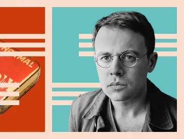 A portrait photo of Joshua Cohen in front of the S-shaped Schocken logo on a light blue background.