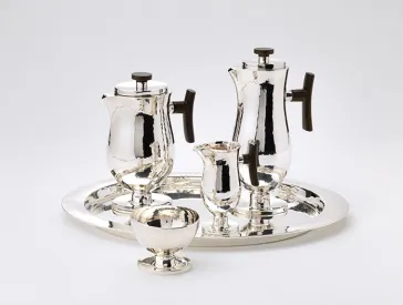 The image shows a tray with two coffee and tea kettles and two cups. The material is silver.