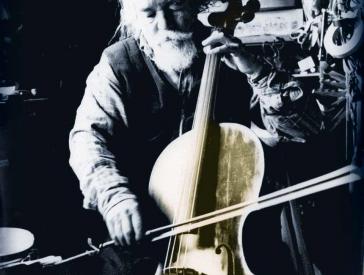 Book cover showing an elderly, white-haired, bearded gentleman playing the cello.