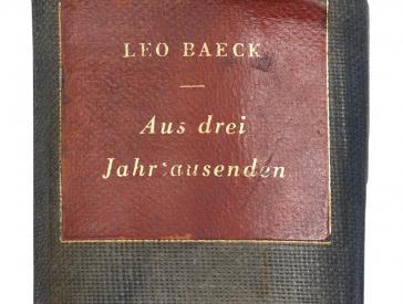 Cover of a book in black and red with golden letters (detail)