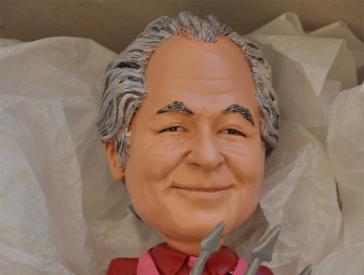 Plastic figure of a man with gray hair.