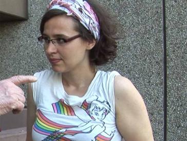 An older woman with glasses and headscarf (left in the picture) is talking to a younger woman who also wears glasses and is standing at the right edge of the picture.