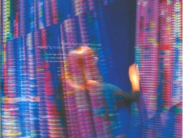 Colorful glitter curtain made of chains, and a blurred woman who is moving the curtain