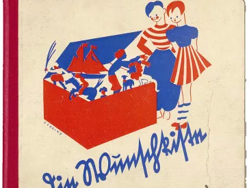 Book cover of the title Die Wunschkiste with blue-red drawing of two children looking curiously into an open box