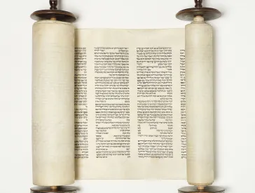 Torah scroll with wooden handles and Hebrew characters