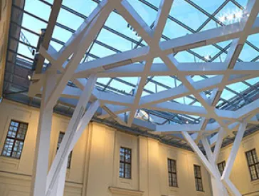Interior view of the glass courtyard with special attention to the steel construction on the ceiling.