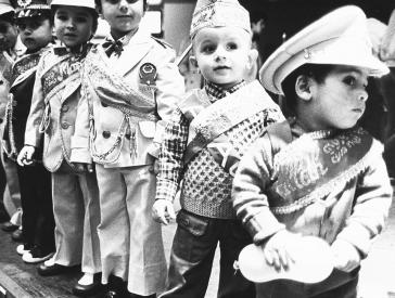 Schwarz-weiß-Foto: Kinder aufgereiht und gekleidet in Uniformen.