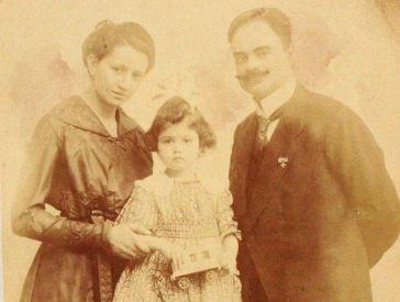 Studio portrait of a woman and a man with a child, about four years old.