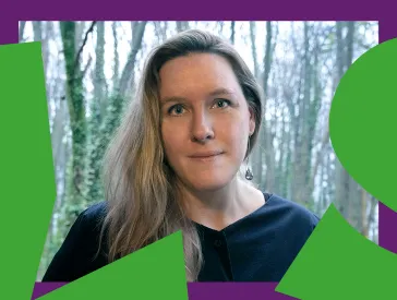 Woman with long hair looks friendly into the camera.