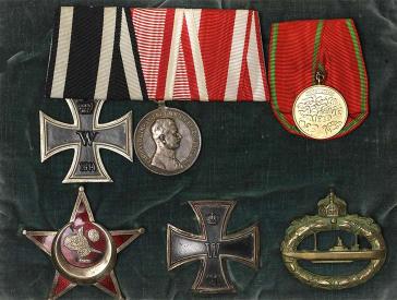 Photo of three medals on a velvet cushion.