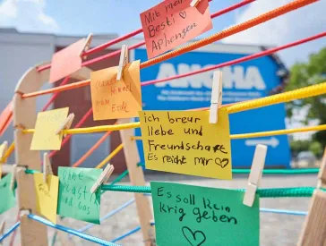 Bunte Wäscheleinen an denen bunte Zetteln mit Kinderschrift hängen.