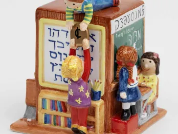 Bunte Spendendose mit kleinen Kinderfiguren.