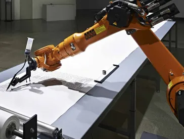 A robotic arm writes a text,