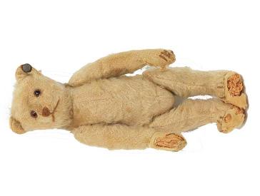 Brown plush bear with movable arms and legs, black button eyes.