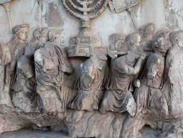 Damaged relief: a group of men carrying a Hanukkah candelabrum on their shoulders.