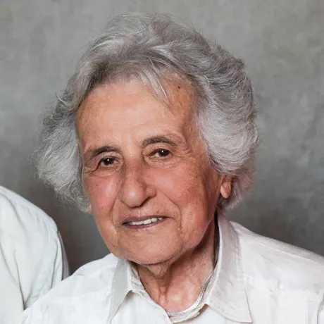 Portrait photo of an elderly woman looking friendly into the camera.