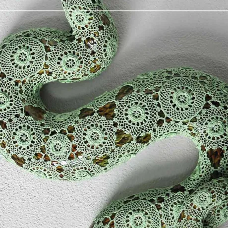 A snake on crocheted fabric.