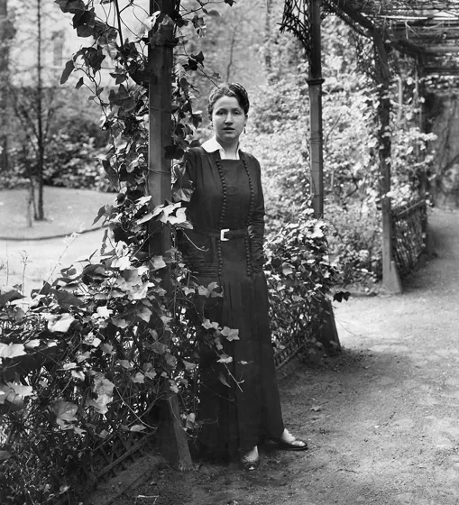  Black and white photo of a woman in a park.
