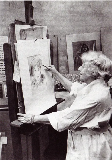  A woman stands at an easel and draws a portrait of a woman.