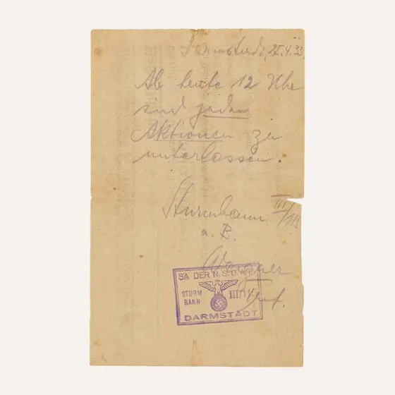Handwritten note, stamped and signed by SA Troop Leader Wagner. The text reads “Darmstadt, 25 April 1933. From noon today, all actions are to stop.”