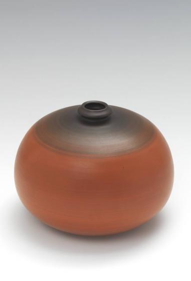 Orang and brown spherical vase with a small opening 
