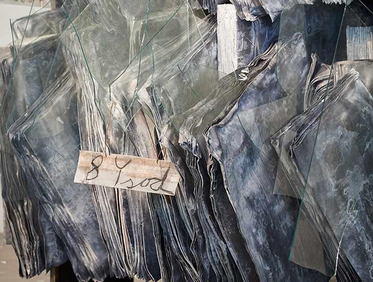 Sculpture of a library made of lead with inserted glass fragments