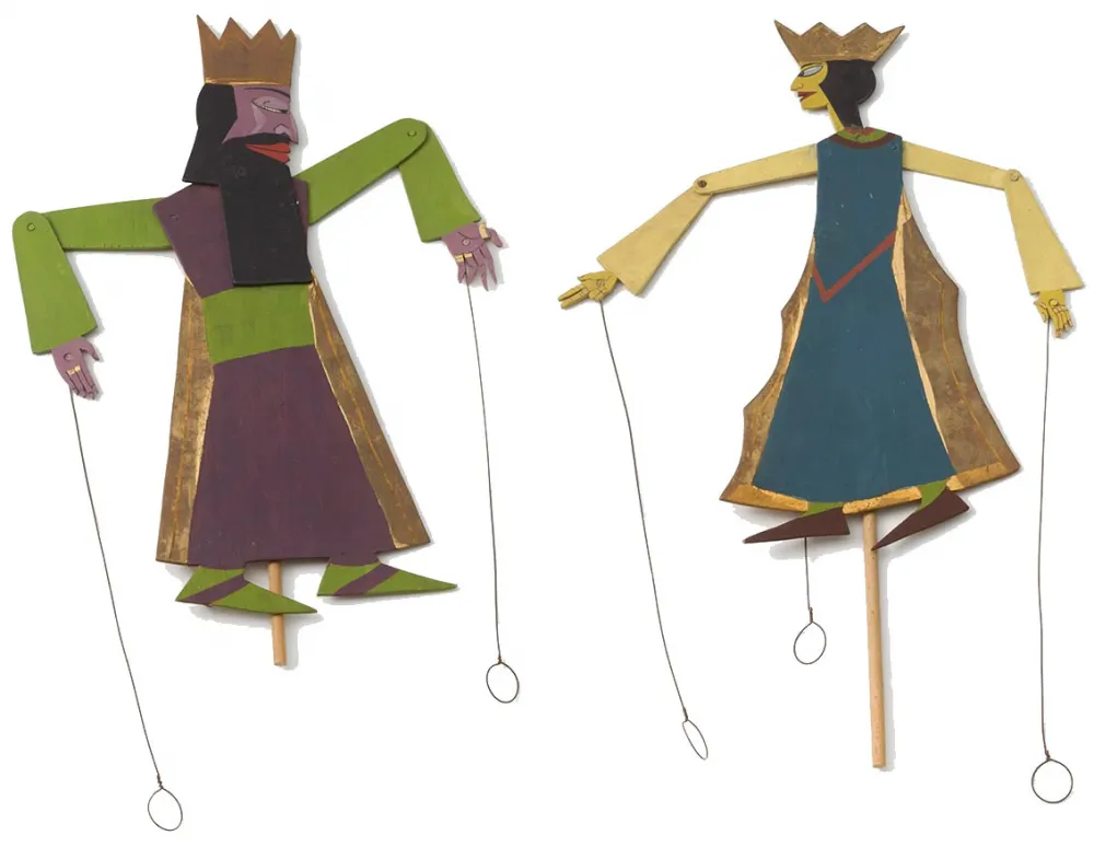 Two puppets with crowns and moving parts, which are connected with rivets