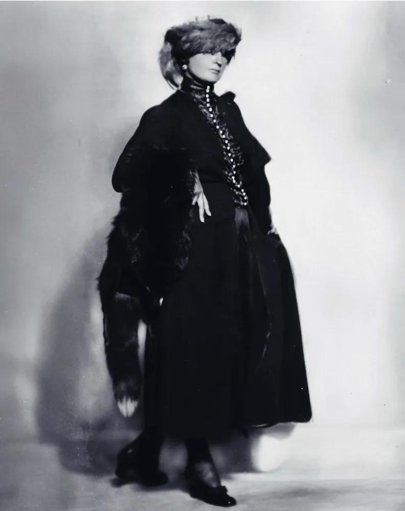 Fotografie von einer posierenden Frau mit Mantel und Mütze.